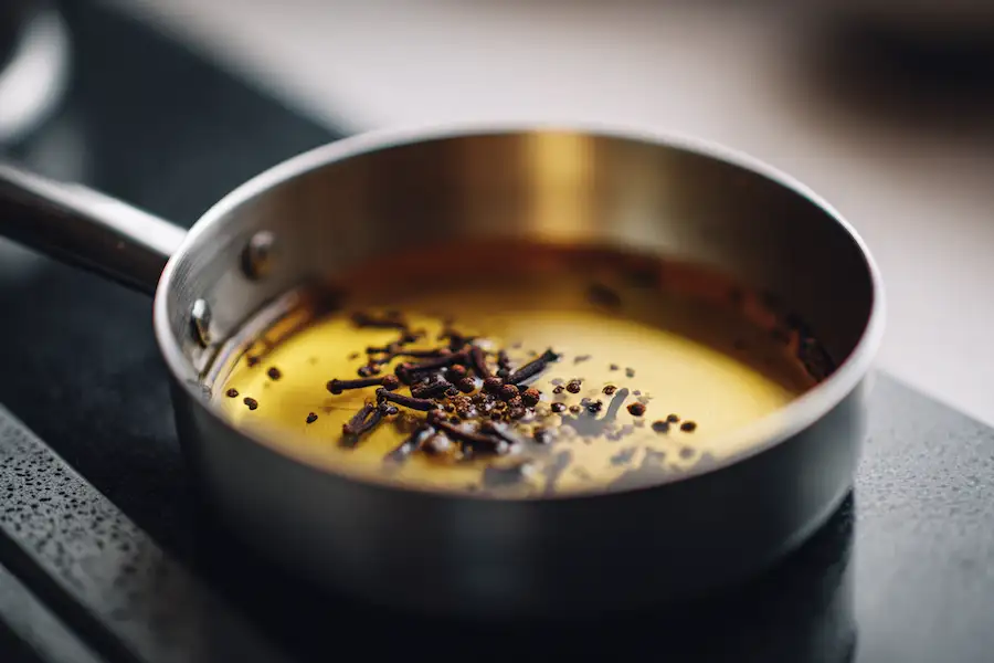 clove oil infusion process pan closeup